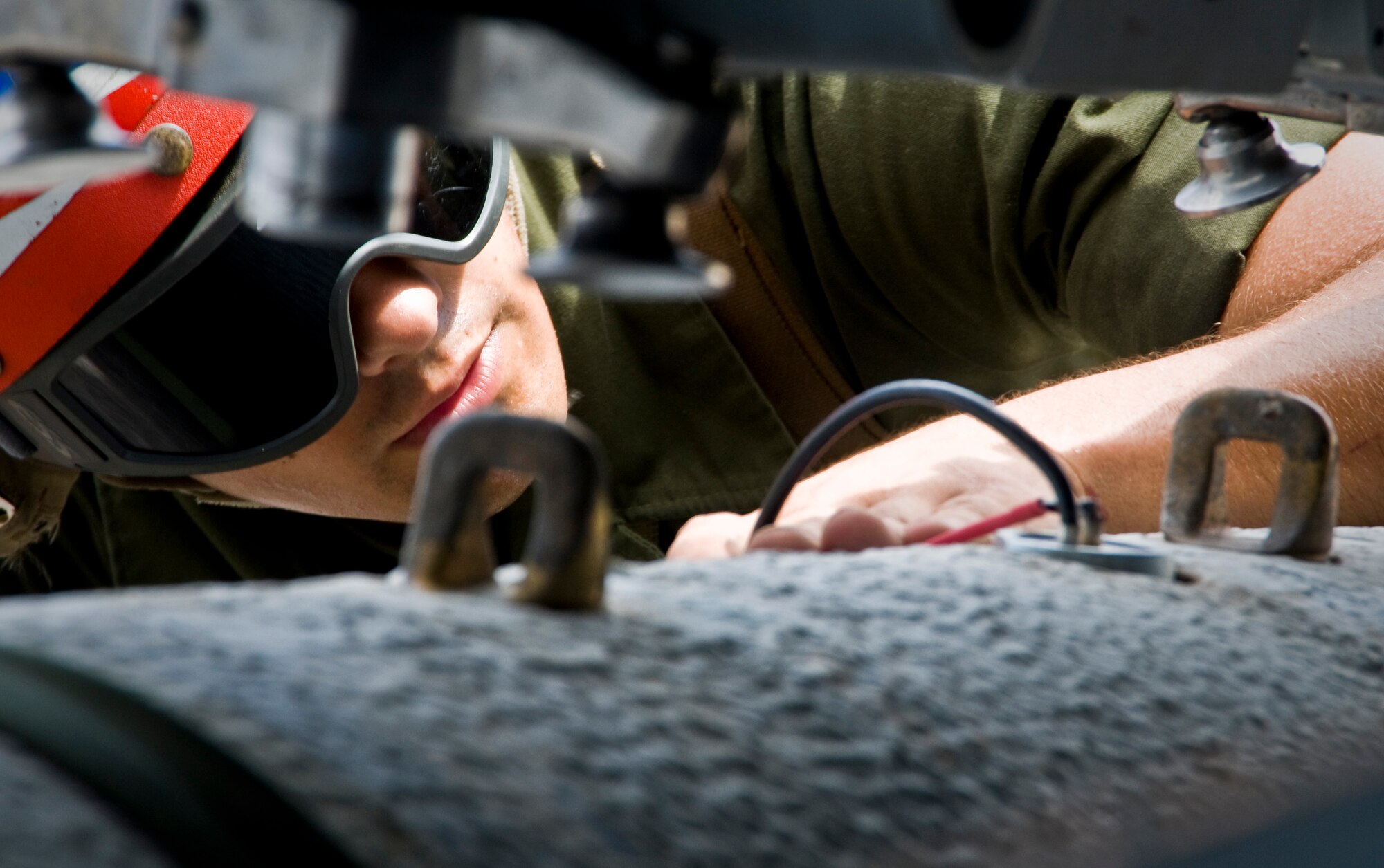 ANDERSEN AIR FORCE BASE, Guam—U.S. Marine Corps Pfc. Gregory Morris, a Marine Fighter Attack Squadron 115 aviation ordnance technician, from Marine Corps Air Station Iwakuni, Japan, loads ordnance onto an F/A-18 Hornet during training here, Oct. 20. U.S. Marine and U.S. Navy units worked closely with Airmen during their month-long deployment to the base. (U.S. Air Force photo by Senior Airman Benjamin Wiseman/Released)