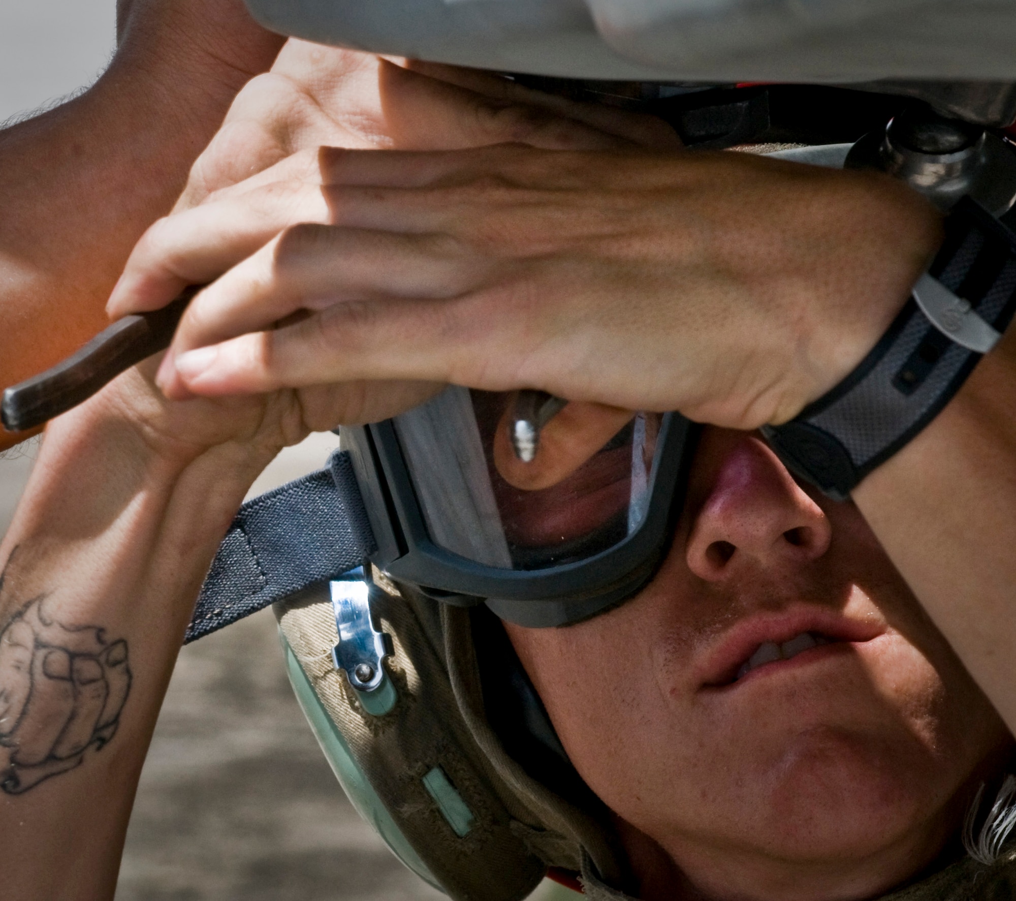 ANDERSEN AIR FORCE BASE, Guam—A member of Marine Fighter Attack Squadron 115 from Marine Corps Air Station Iwakuni, Japan, attaches a bomb rack onto an F/A-18 Hornet fighter jet during training here, Oct. 20. U.S. Marine and U.S. Navy personnel were training to improve their combat efficiency throughout the month-long deployment to the base. (U.S. Air Force photo by Senior Airman Benjamin Wiseman/Released)