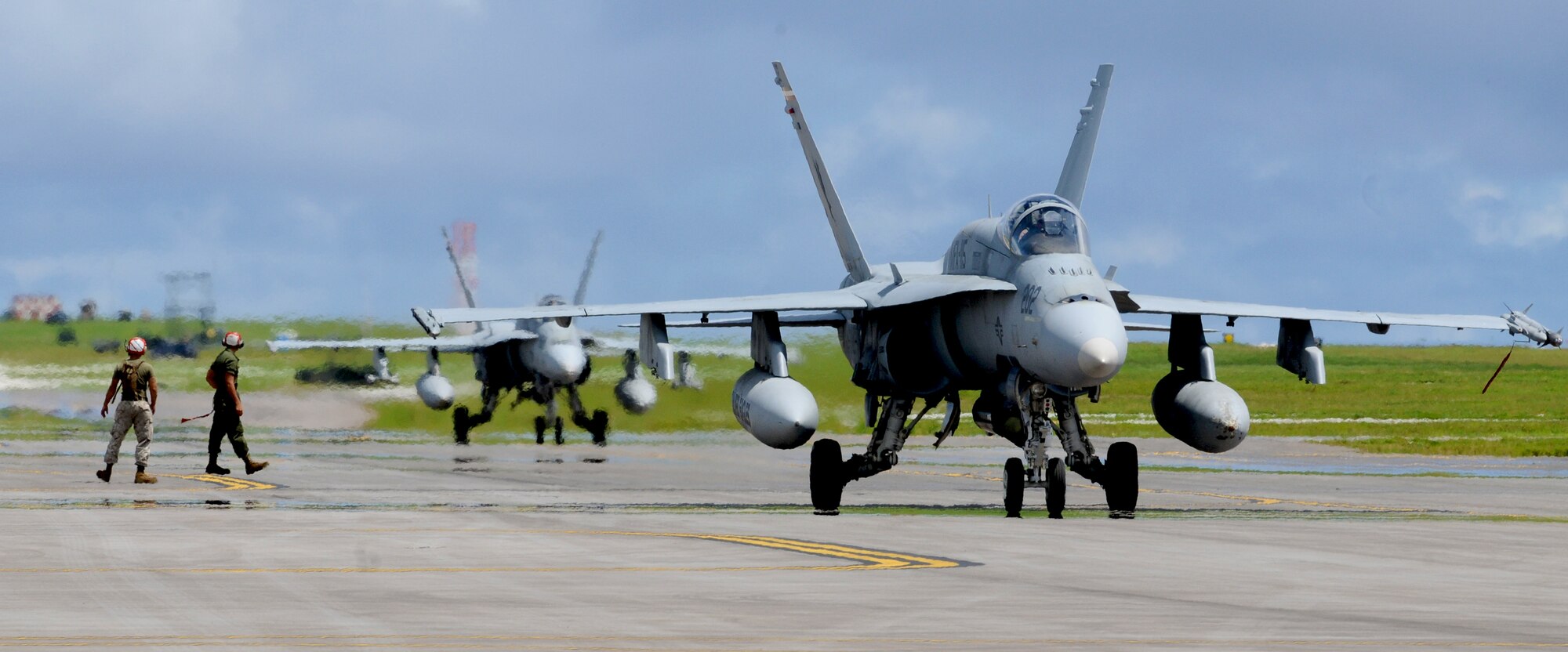 ANDERSEN AIR FORCE BASE, Guam—Two F/A-18 Hornet fighter jets from Marine Corps Air Base Iwakuni, Japan, during training here, Oct. 20.  The Marine Aviation Logistics Squadron 12, Marine Fighter Attack Squadron 115 and Strike Fighter Squadron 94 arrived on Oct. 6, to begin aerial and ground training on Andersen as part of a month-long deployment to improve combat efficiency.  (U.S. Air Force photo by Senior Airman Benjamin Wiseman/Released)