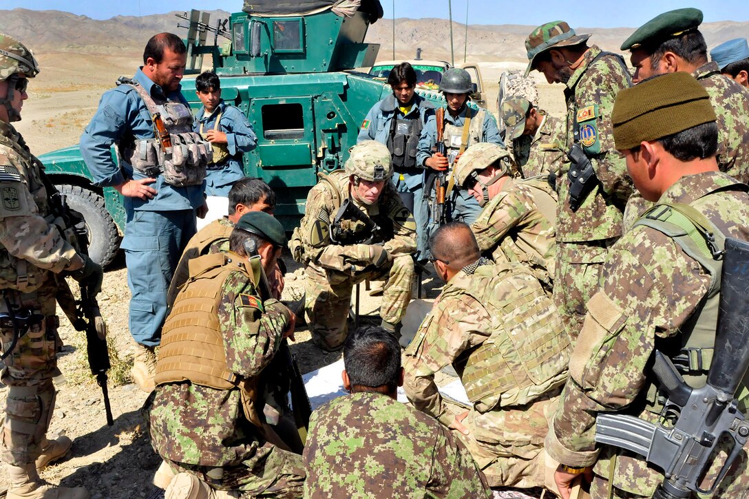 U.S. Army Brig. Gen. Gary Volesky, center, discusses strategy with U.S. soldiers, Afghan soldiers and police during Operation Shamshir in the Mata Khan district of Paktika Province, Afghanistan, Oct. 19, 2011. Volesky is the deputy commanding general of the 1st Cavalry Division.