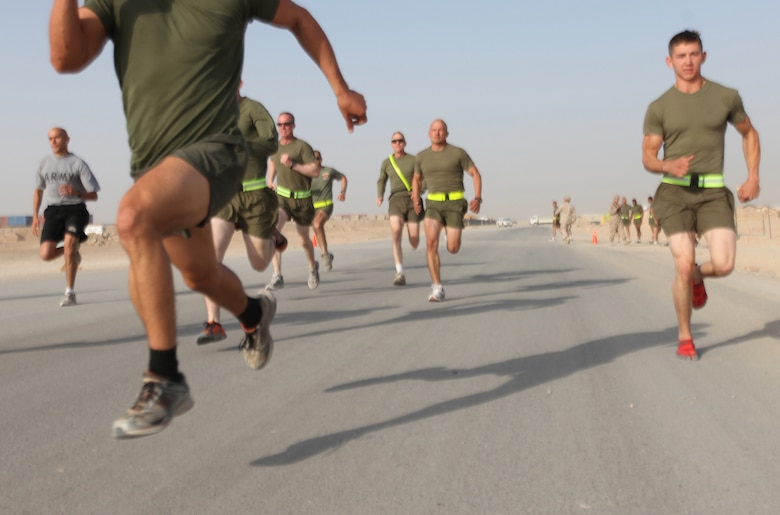 Runners dash toward the finish line during the 400-meter run portion of the 2nd Marine Logistics Group (Forward)'s Iron Man Competition aboard Camp Leatherneck, Afghanistan, Oct. 22. The event tested the physical resolve of troops across the base. (U.S. Marine Corps photo by Sgt. Justin J. Shemanski)