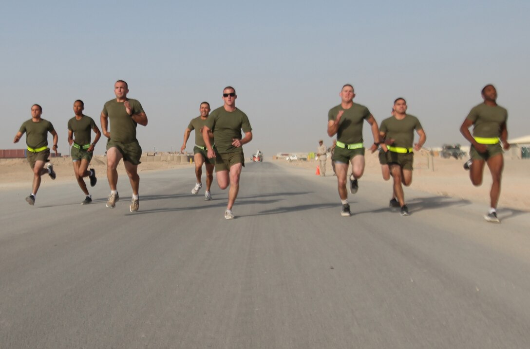 Runners dash toward the finish line during the 400-meter run portion of the 2nd Marine Logistics Group (Forward)'s Iron Man Competition aboard Camp Leatherneck, Afghanistan, Oct. 22. The event tested the physical resolve of troops across the base. (U.S. Marine Corps photo by Sgt. Justin J. Shemanski)