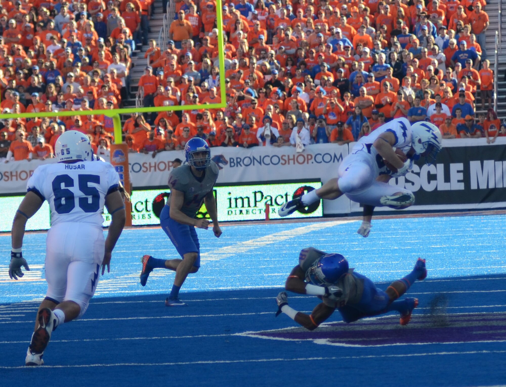 Air Force running back Anthony LaCoste hurdles a Boise State defender during the Falcons-Broncos game in Boise, Idaho, Oct. 22, 2011. LaCoste had 54 kick-return yards in the Falcons' 37-26 defeat. (U.S. Air Force photo/Tech. Sgt. Vann Miller)