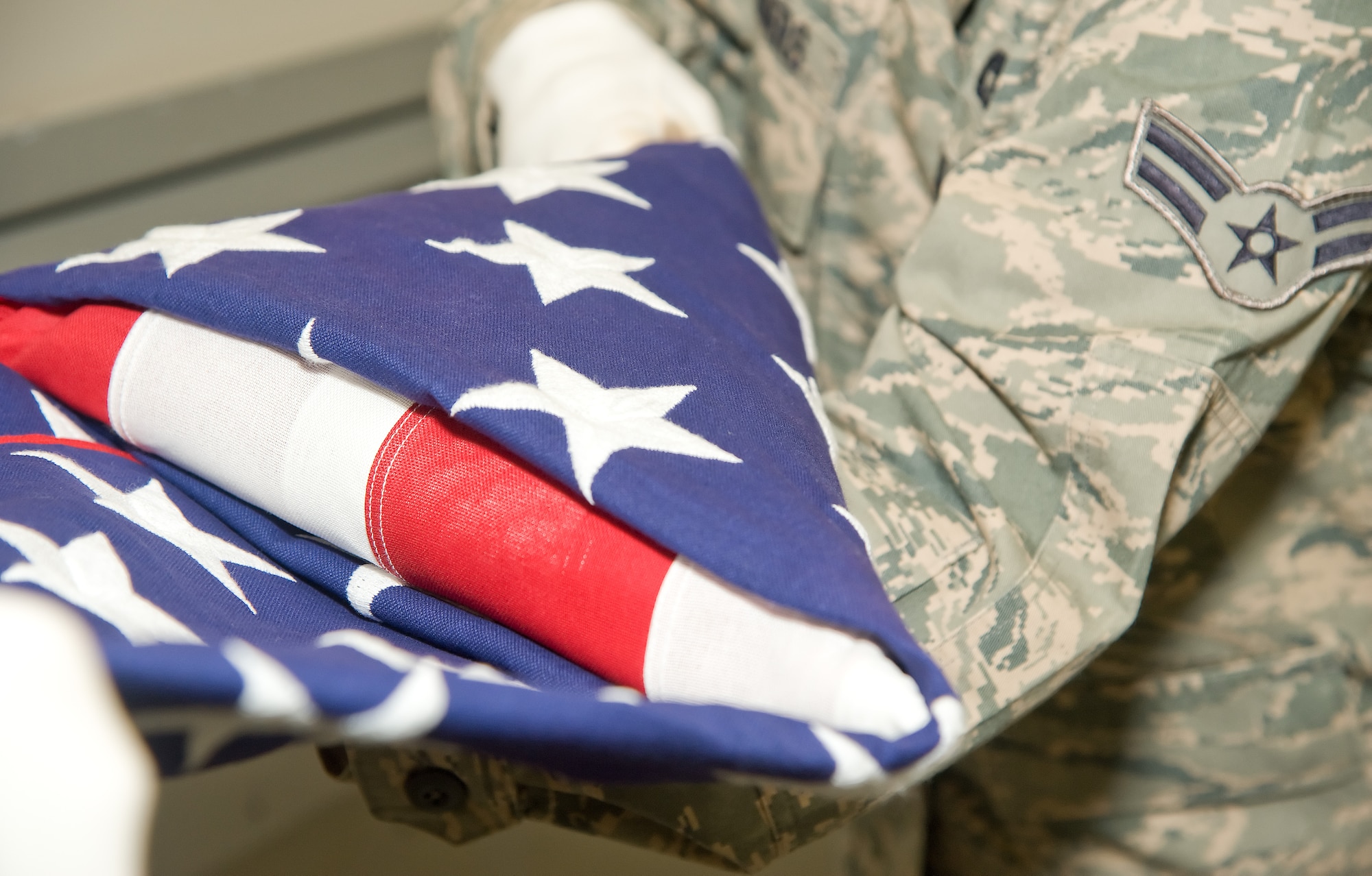 Ceremonial guardsmen fold the American flag Oct. 20, 2011, at the Honor Guard facility at Dover Air Force Base, Del. Honor Guard members learn almost all the necessary skills to conduct drill and ceremony while in Training Flight. (U.S. Air Force photo by Adrian Rowan)  

