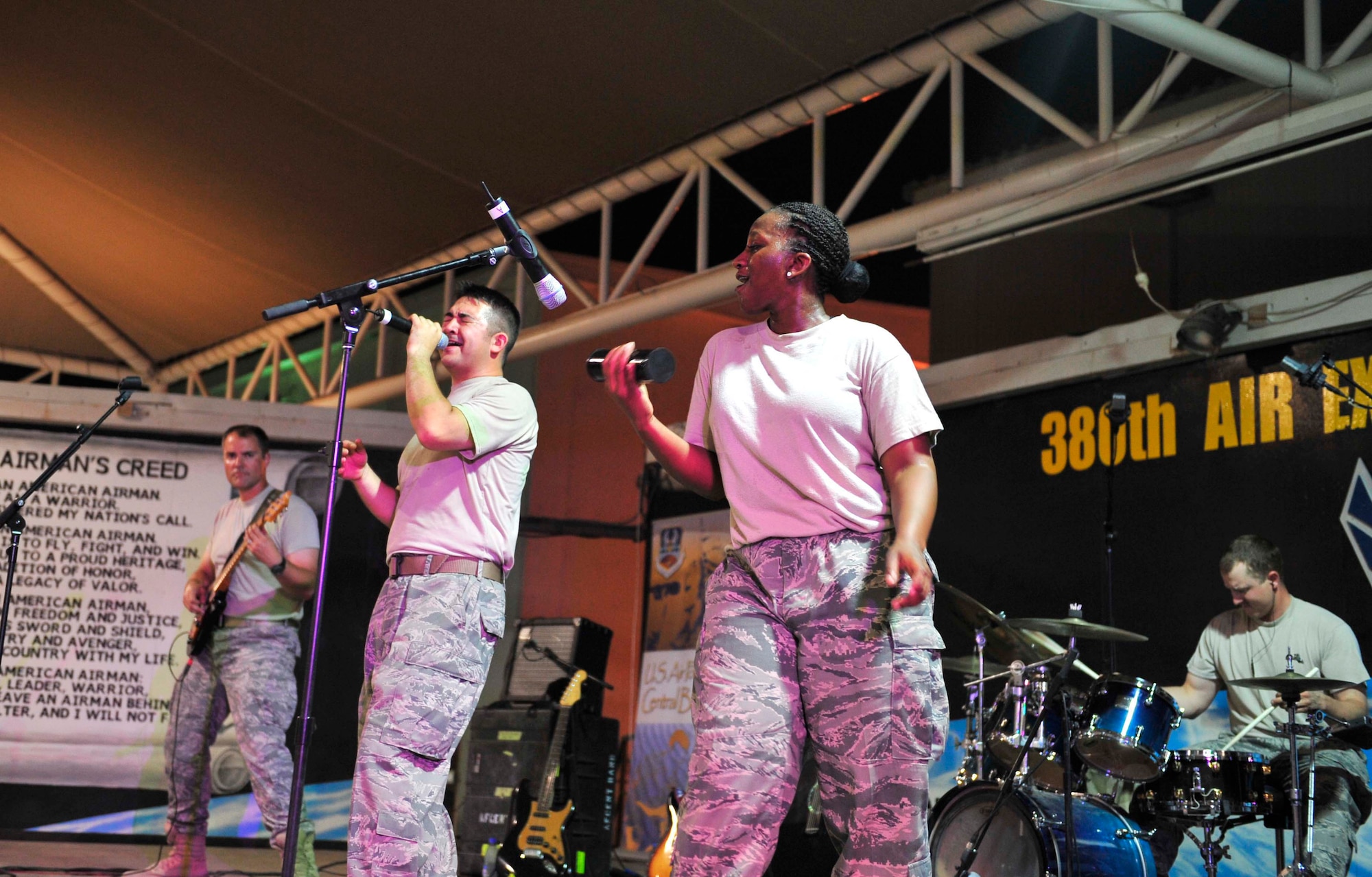 Top Cover, the U.S. Air Forces Central Command band, rocks out during an evening performance Oct. 19, 2011, at the 380th Air Expeditionary Wing in Southwest Asia. The band played several small acoustic sets at back shops and a pair of full-length powered shows during their visit to the wing to raise the morale of the deployed Airmen, Soldiers and Sailors at the wing. (U.S. Air Force photo/Tech. Sgt. Patrick Mitchell)