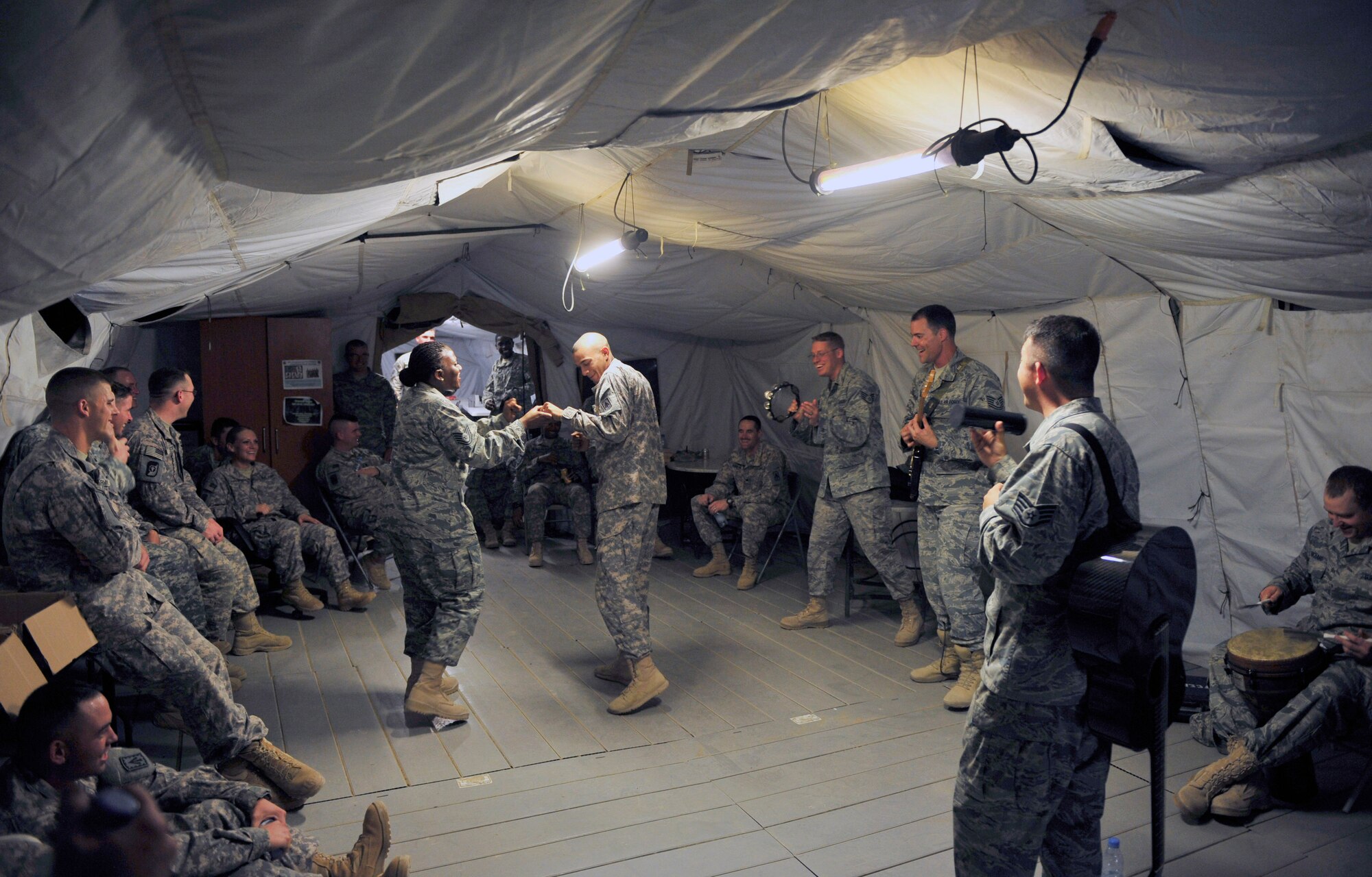Top Cover, the U.S. Air Forces Central Command band, rocked it out with Soldiers at the 3rd Battalion, 4th Air Defense Artillery Regiment Oct. 19, 2011, during the band?s visit to the 380th Air Expeditionary Wing in Southwest Asia. The band played several small acoustic sets at back shops and a pair of full-length powered shows during their visit to the wing to raise the morale of the deployed Airmen, Soldiers and Sailors at the wing. (U.S. Air Force photo/Tech. Sgt. Patrick Mitchell)