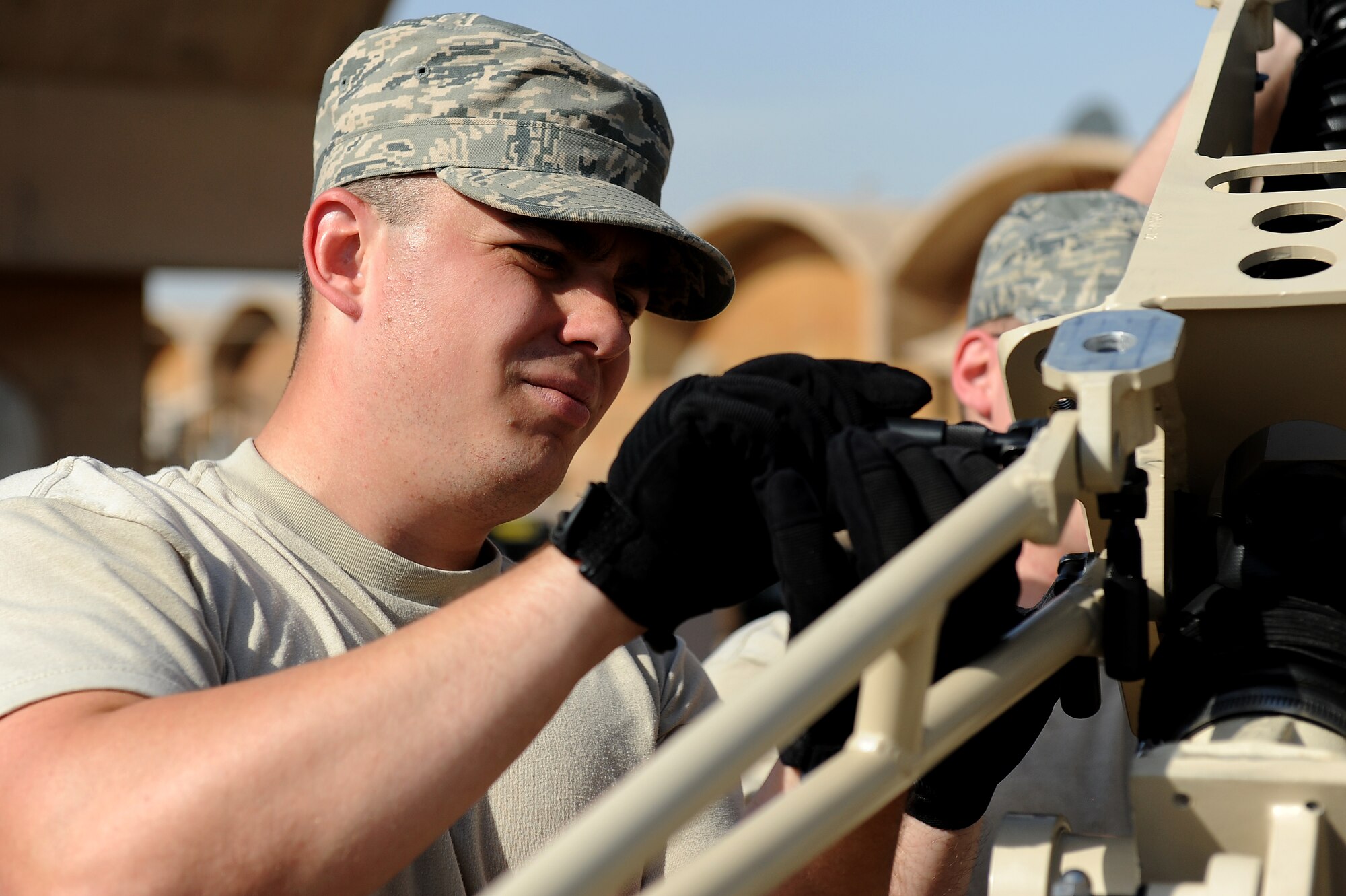 Senior Airman Jarod Bierman, 5th Combat Communications Group, Robins Air Force Base, Ga., helps assemble a tactical satellite communications called a ground multiband terminal, or GMT, at Sather Air Base, Iraq, Oct. 7, 2011. The tactical communications network is being set up for Airmen on the ground as the U.S. military continues preparation for the scheduled withdrawal. Bierman calls Chicago home. (U.S. Air Force photo/Staff Sgt. Mike Meares)