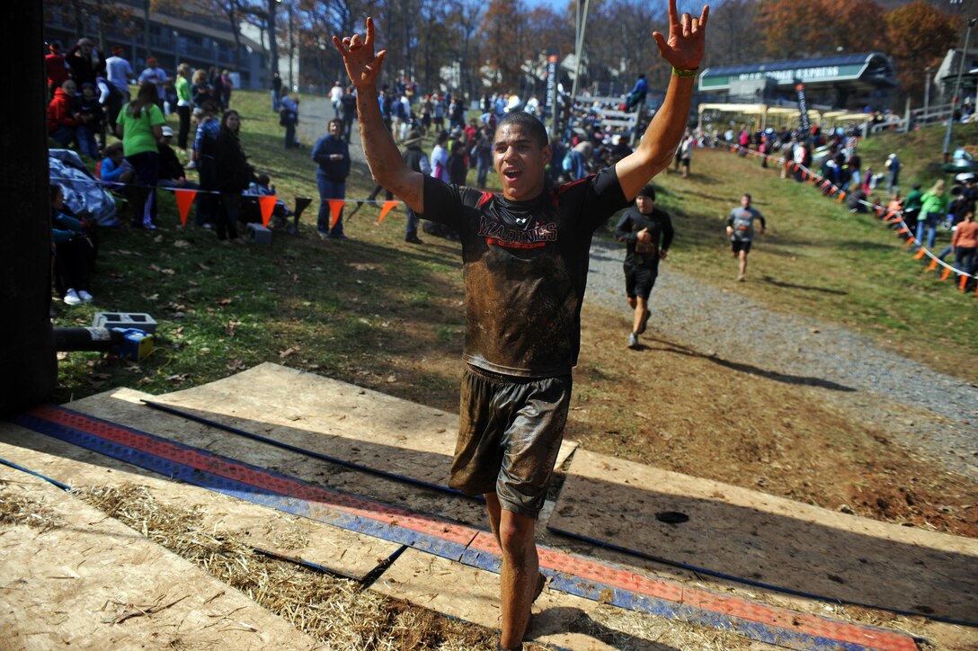 Lance Cpl. Malcolm Elzie, Company A ceremonial marcher, crosses the finish line of Tough Mudder at Wintergreen, Va., Oct. 22, 2011. Tough Mudder, a 10-mile race through rough terrain and 27 obstacles, was the 12th of 17 events that compose Marine Barracks Washington's 2011 Commander's Cup.