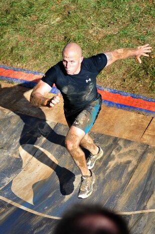 Capt. Eric Dwyer, Company A commander, runs up a quarterpipe during Tough Mudder at Wintergreen, Va., Oct. 22, 2011. Tough Mudder, a 10-mile race through rough terrain and 27 obstacles, was the 12th of 17 events that compose Marine Barracks Washington's 2011 Commander's Cup.