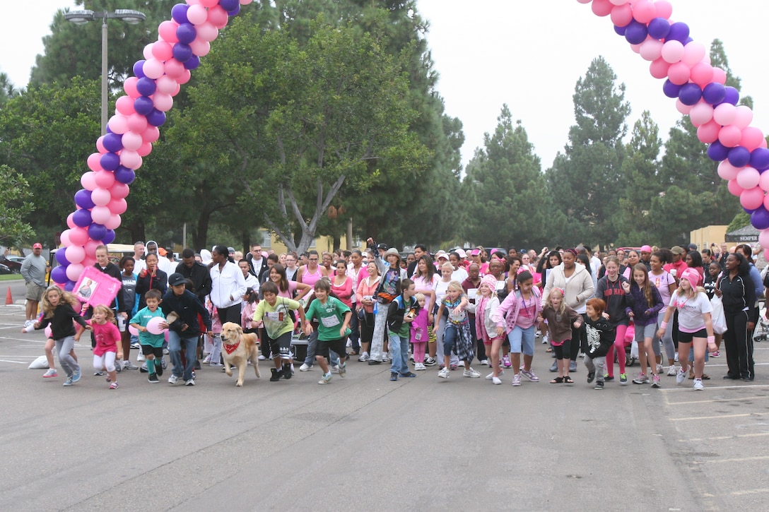 Children take off as the horn blows to start the mile-and-a-half walk around the Marine Corps Recruit Depot Oct. 22. The MCRD Exchange Mall was filled with pink Saturday during the Make a Difference Day 2011 Walk and Wellness Expo hosted by Marine Corps Community Services. This is the seventh year the depot has hosted Make a Difference Day to raise awareness of breast cancer and domestic violence.