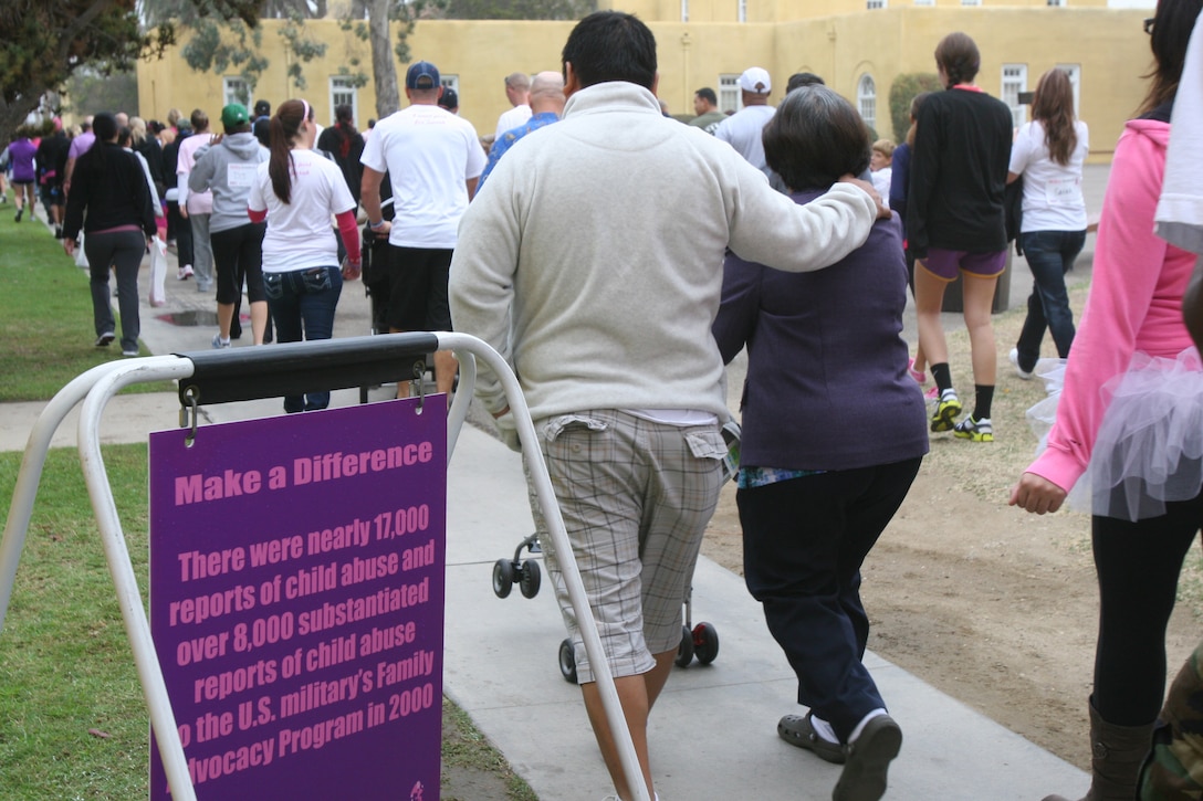 Participants walk around Marine Corps Recruit Depot San Diego Oct. 22 for the Make a Difference Day 2011 Walk and Wellness Expo at the MCRD Exchange Mall. The event was held to raise awareness on breast cancer and domestic violence.The mile-and-a-half walk was marked with signs that contained statistics on the two causes. "The facts help remind the participants why they're here," said Andrea Callahan, Marine Corps Community Services health promotions coordinator. "The more information they have, the better they will be to look after their families."