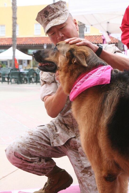 Brig. Gen. Daniel D. Yoo, Marine Corps Recruit Depot San Diego commanding general, pets a therapy dog during Make a Difference Day 2011 Walk and Wellness Fair aboard MCRD Oct. 22. The day was hosted by Marine Corps Community Services to help raise awareness for domestic violence and breast cancer. "I think the key to awareness is by educating people," said Yoo. "These events are important because such a large population is affected by (domestic violence and breast cancer)."
