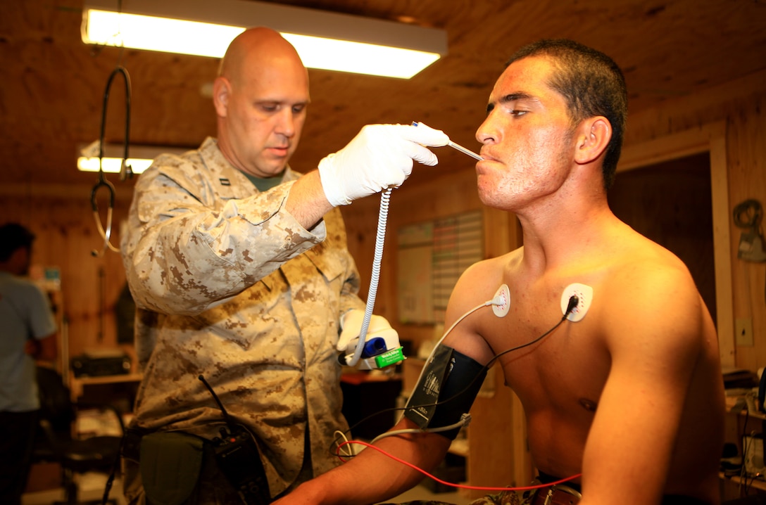 Navy Lt. Scott LaPanne, a nurse with the Delaram Shock Trauma Platoon, Bravo Surgical Company, Marine Air-Ground Task Force Support Battalion 11.2, 2nd Marine Logistics Group (Forward), takes the temperature of an Afghan National Army soldier in the STP aboard Forward Operating Base Delaram II, Afghanistan, Oct. 23.  The medical personnel at the STP see soldiers as well as Afghan locals on a regular basis.  (U.S. Marine Corps photo by Cpl. Katherine M. Solano)