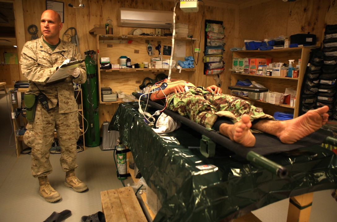 Navy Lt. Scott LaPanne, a nurse with the Delaram Shock Trauma Platoon, Bravo Surgical Company, Marine Air-Ground Task Force Support Battalion 11.2, 2nd Marine Logistics Group (Forward), records the vitals of an Afghan National Army soldier in the STP aboard Forward Operating Base Delaram II, Afghanistan, Oct. 23.  The medical personnel at the STP treat a wide variety of injuriesand ailments, from gunshot wounds to chest pain. (U.S. Marine Corps photo by Cpl. Katherine M. Solano)