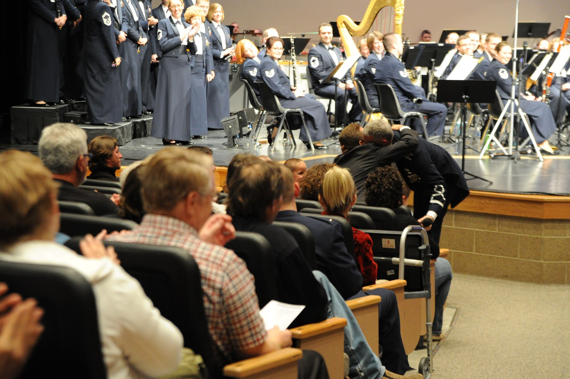 Col. A. Philip Waite, U.S. Air Force Band commander and conductor, welcomes hugs from his family Oct. 22 at North Star High School, Lincoln, Neb. The commander has led the concert band on a 25-day community relations tour across Montana, Wyoming, Nebraska and South Dakota. He received a surprise visit from family members at the final show in Nebraska. (U.S. Air Force photo by Airman 1st Class Tabitha N. Haynes)
