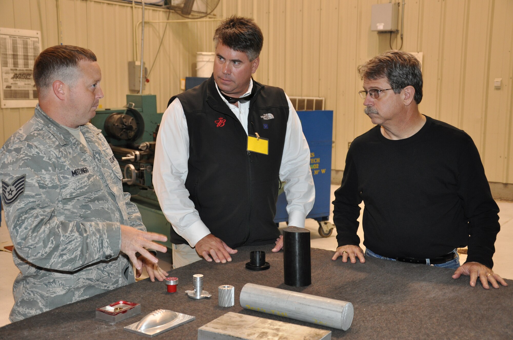 Tech. Sgt. Jamie Mozingo talks to Mr. Robert Jeffryey's of R.A. Jeffrey's Distributing and David Smith of Bank of America about the 916th maintenance backshops during the wing's Reservist for a Day program on Saturday, Oct. 22. The event was held as one of nine activities to celebrate 25 years of re-activation. (USAF photo by Maj. Erin Karl, 916ARW/PA)