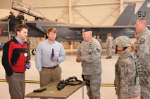 Tech. Sgt. Tom Welch, 916th Security Forces, talks wtih members of the community during when the wing hosted the Business After Hours event in honor of their 25th anniversary on Oct. 20, 2011. (USAF photo by Senior Airman Meredith Thomas, 916ARW/PA)