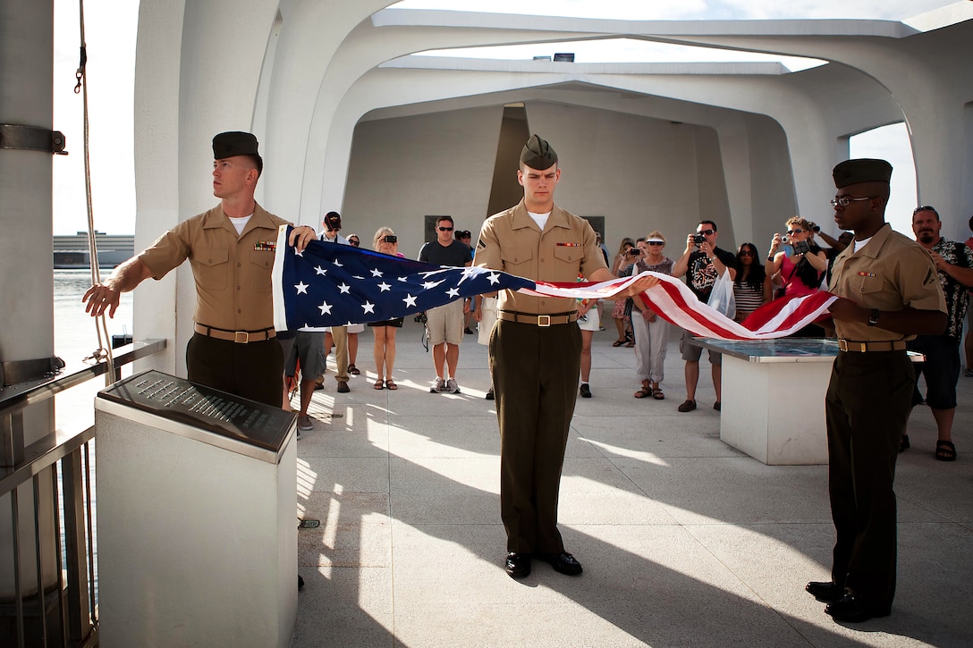 Members of Headquarters and Service Battalion, U.S. Marine Corps Forces, Pacific color guard prepare to raise a flag over the USS Arizona Memorial here Oct. 24. The Marine Corps League Detachment 819 from Citrus County, Florida, sent it so it could be raised over the USS Arizona Memorial in honor of Ted Archambault, a former Marine and Pearl Harbor survivor.