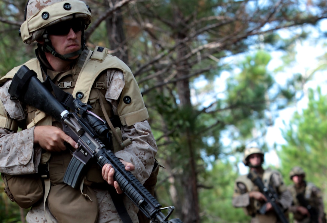 A Marine with 8th Communication Battalion, 2nd Marine Division, steps carefully while patrolling through a wooded area during the expeditionary communication training held aboard Marine Corps Base Camp Lejeune, N.C., Oct. 24. During their training, the Marines took part in scenarios in which squads established patrol bases and began sending out patrols in search of the enemy squad while remaining prepared to defend against assaults and ambushes.