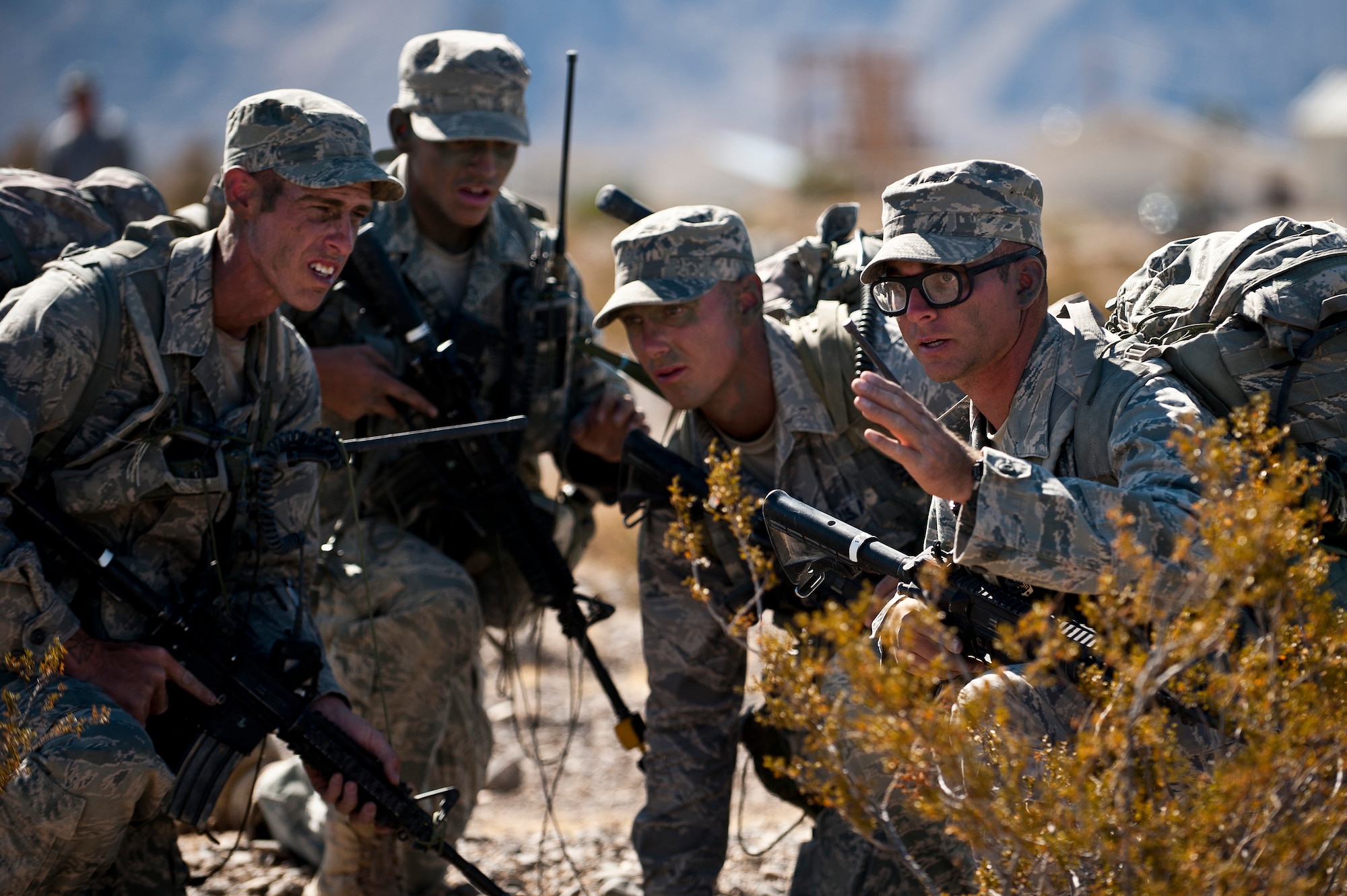 U.S. Air Force Airmen training as squad leaders discuss tactics for an ambush training mission during the Ranger Assessment and Selection Course Oct. 21, 2011, at the Nevada Test and Training Range. Airmen must attend the RAS Course before going to the U.S. Army Ranger School, which is designed to train armed forces personnel to conduct combat operations within enemy lines. (U.S. Air Force photo by Airman 1st Class George Goslin/Released)