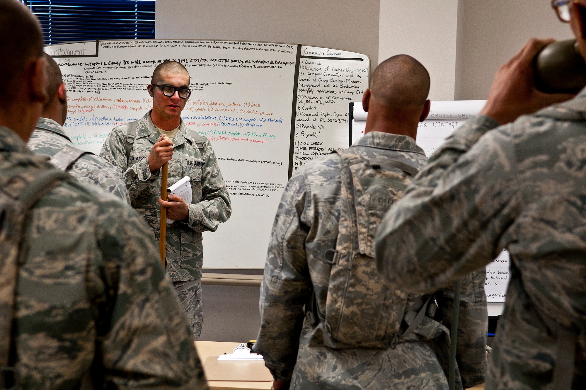 U.S. Air Force 1st Lt. Calvin Glass, 90th Ground Combat Training Squadron field officer from Francis E. Warren Air Force Base, Wyo., instructs Airmen during their planning phase for a training mission during the Ranger Assessment and Selection Course Oct. 21, 2011, at the Nevada Test and Training Range. Airmen must attend the RAS Course before going to the U.S. Army Ranger School, which is designed to train armed forces personnel to conduct combat operations within enemy lines. (U.S. Air Force photo by Airman 1st Class George Goslin/Released)