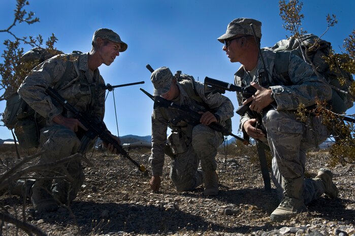 U.S. Air Force security forces Airmen acting squad leaders discuss tactics prior to an ambush training mission during the Ranger Assessment and Selection Course Oct. 21, 2011, at the Nevada Test and Training Range. Airmen must attend the RAS Course before going to the U.S. Army Ranger School, which is designed to train armed forces personnel to conduct combat operations within enemy lines. (U.S. Air Force photo by Airman 1st Class Daniel Hughes/Released)