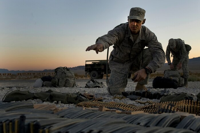 U.S. Air Force Staff Sgt. Jake McLeod, 60th Security Forces Squadron security forces craftsman from Travis Air Force Base, Calif., points to where full magazines are put before a training mission during the Ranger Assessment and Selection Course Oct. 21, 2011, at the Nevada Test and Training Range. Airmen must attend the RAS Course before going to the U.S. Army Ranger School, which is designed to train armed forces personnel to conduct combat operations within enemy lines. (U.S. Air Force photo by Airman 1st Class Daniel Hughes/Released)
