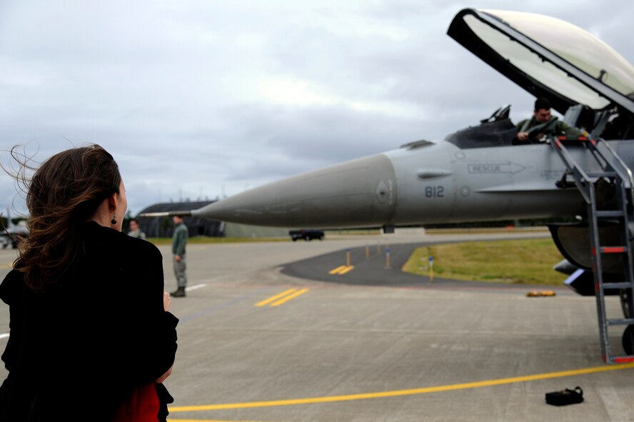 MISAWA AIR BASE, Japan - Kerry Harding, left, waits for her husband U.S. Air Force Capt. Jeff Harding, 13th Fighter Squadron, to step down from his F-16 Fighting Falcon here Oct. 24. Several F-16 Fighting Falcons, with the 13 FS, returned home after an approximate one month long stay at Eielson Air Force Base, Alaska, in support of Operation Noble Eagle, Red Flag-Alaska and Distant Frontier exercise. (U.S. Air Force photo/Tech. Sgt. Marie Brown)