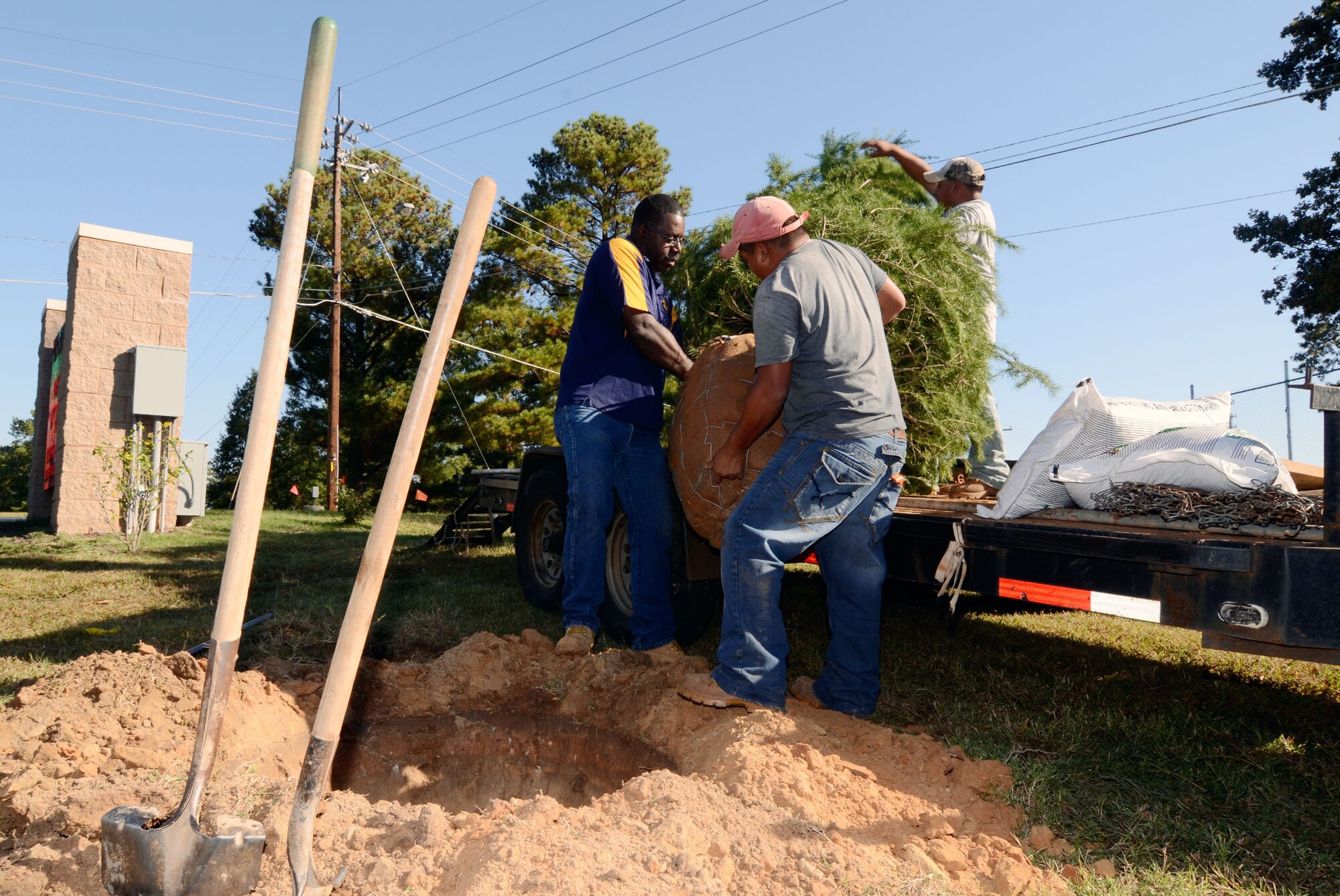 Tim Starks, a landscaping contractor from Lithonia, Ga., and his crew off-load a new base Christmas tree here Oct. 24. The tree was donated by Chuck Berry of Covington, Ga., and Starks. "Christmas is a big deal for us," said Berry. "We look forward to sharing this tree with Dobbins' servicemembers and anyone else who may pass by the main gate and see it." (U.S. Air Force photo/Don Peek)