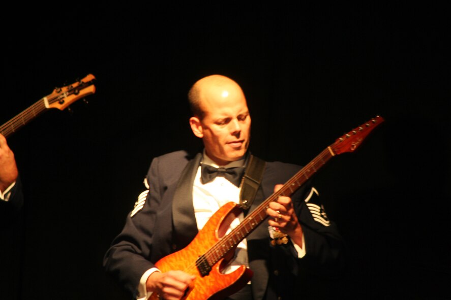 Master Sgt. Jerry Kelley, NCO in charge and lead guitarist for the Starlifter band from the U.S. Air Force Band of Mid-America, plays a tune during the 2011 Air Mobility Command Icon finals Oct. 20, 2011, at Scott Air Force Base, Ill. The Starlifter band played all of the music for the 10 competitors in the Icon competition. (U.S. Air Force Photo/Master Sgt. Scott T. Sturkol)