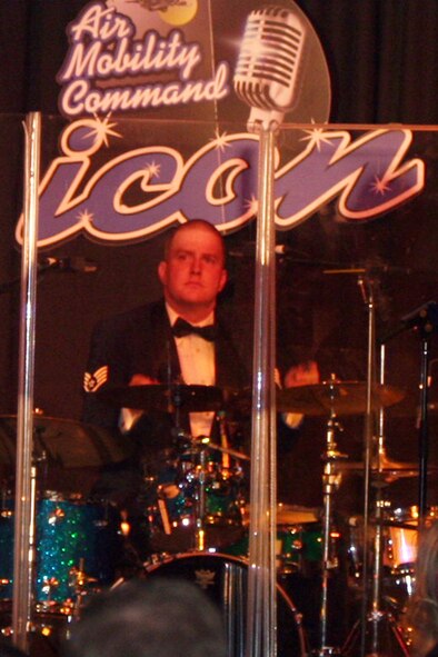 Staff Sgt. Jody Walker, drummer for the Starlifter band from the U.S. Air Force Band of Mid-America, plays a tune during the 2011 Air Mobility Command Icon finals Oct. 20, 2011, at Scott Air Force Base, Ill. The Starlifter band played all of the music for the 10 competitors in the Icon competition. (U.S. Air Force Photo/Master Sgt. Scott T. Sturkol)