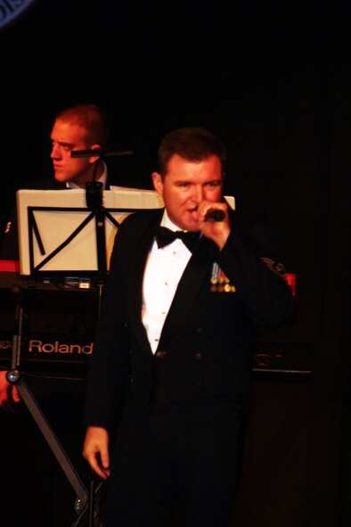 Tech. Sgt. Jamie Gilley, vocalist for the Starlifter band from the U.S. Air Force Band of Mid-America, sings during the 2011 Air Mobility Command Icon finals Oct. 20, 2011, at Scott Air Force Base, Ill. The Starlifter band played all of the music for the 10 competitors in the Icon competition. (U.S. Air Force Photo/Master Sgt. Scott T. Sturkol)