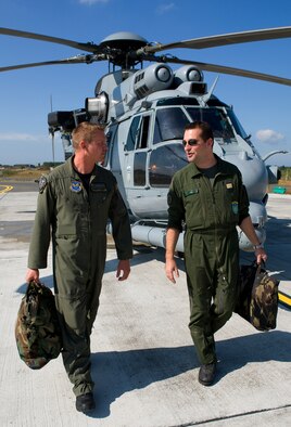 U.S. Air Force Maj. Scott Adams, 0167th Pyrenees Squadron helicopter pilot, and French Air Force Capt. Damien Zilka, 0167th Pyrenees helicopter pilot, discuss tactics during exercise Combined Joint Personnel Recovery Standardization Course at Cazaux Air Base, France. One of Adam's duties as a member of the 0167th Pyrenees is to coordinate the squadron's participation in international exercises. (Courtesy photo)
