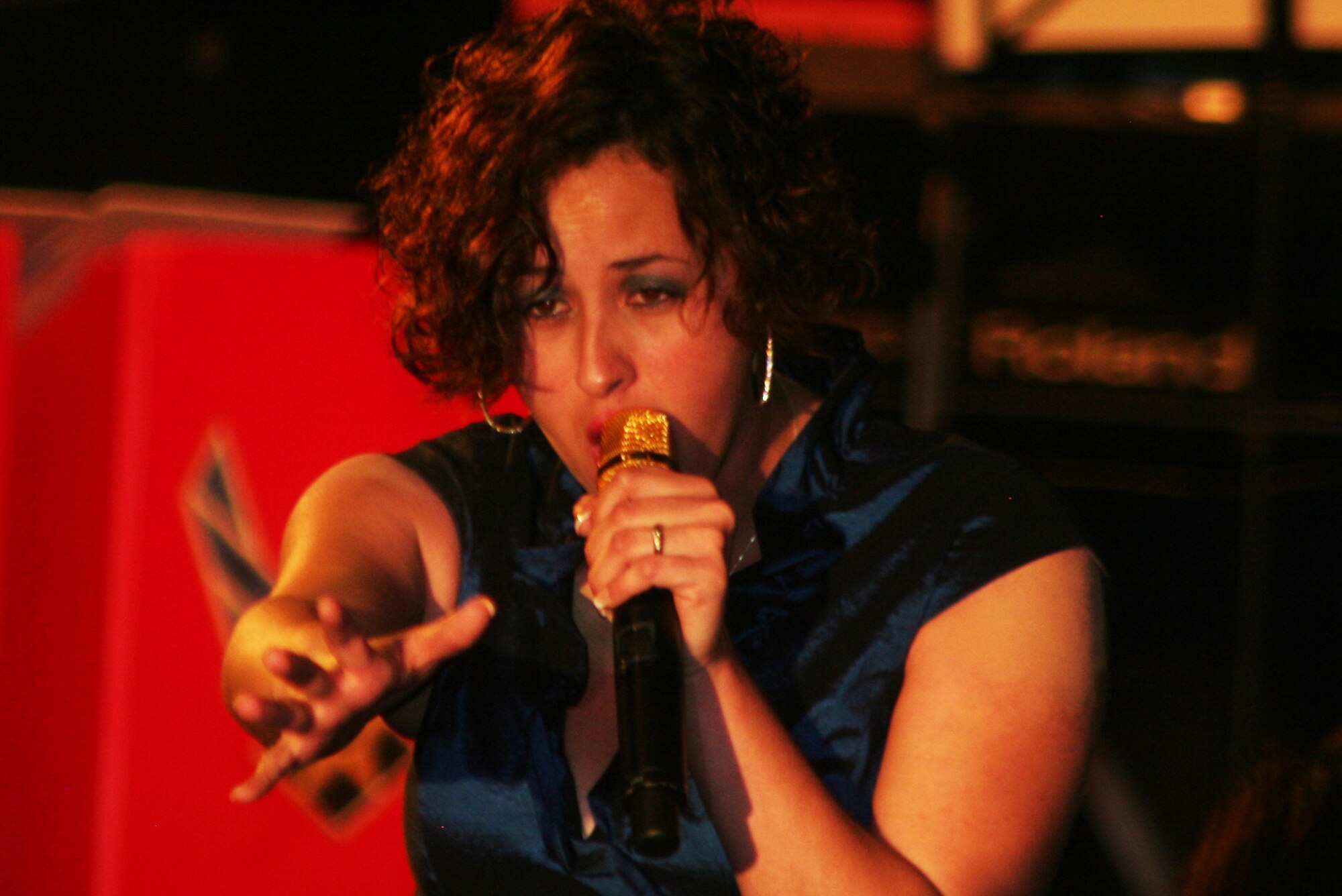 Senior Airman Naomi Scott sings "Rolling in Deep" during the Air Mobility Command Icon finals competition Oct. 20, 2011, at Scott Air Force Base, Ill. Scott made it to the finals by winning the base level competition at Dover AFB, Del., and she took first place in the event. Icon is an AMC commander's initiative to showcase the vocal talents of AMC Airmen. Each AMC base holds Icon contests in July and August to determine their representatives for the command final which takes place at Scott AFB. (U.S. Air Force Photo/Master Sgt. Scott T. Sturkol)