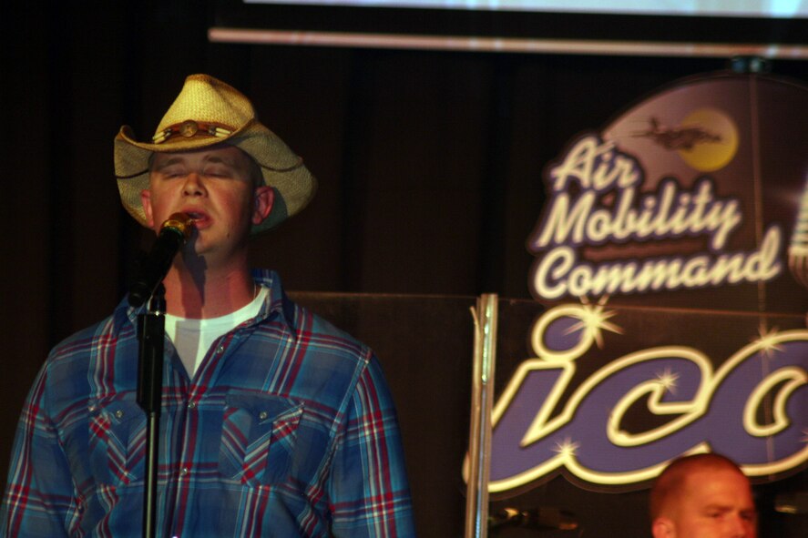 Senior Airman John Maness sings "Muddy Water" during the Air Mobility Command Icon finals competition Oct. 20, 2011, at Scott Air Force Base, Ill. Maness made it to the finals by winning the base level competition at Grand Forks AFB, N.D. Icon is an AMC commander's initiative to showcase the vocal talents of AMC Airmen. Each AMC base holds Icon contests in July and August to determine their representatives for the command final which takes place at Scott AFB. (U.S. Air Force Photo/Master Sgt. Scott T. Sturkol)