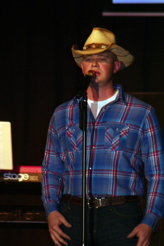 Senior Airman John Maness sings "Muddy Water" during the Air Mobility Command Icon finals competition Oct. 20, 2011, at Scott Air Force Base, Ill. Maness made it to the finals by winning the base level competition at Grand Forks AFB, N.D. Icon is an AMC commander's initiative to showcase the vocal talents of AMC Airmen. Each AMC base holds Icon contests in July and August to determine their representatives for the command final which takes place at Scott AFB. (U.S. Air Force Photo/Master Sgt. Scott T. Sturkol)