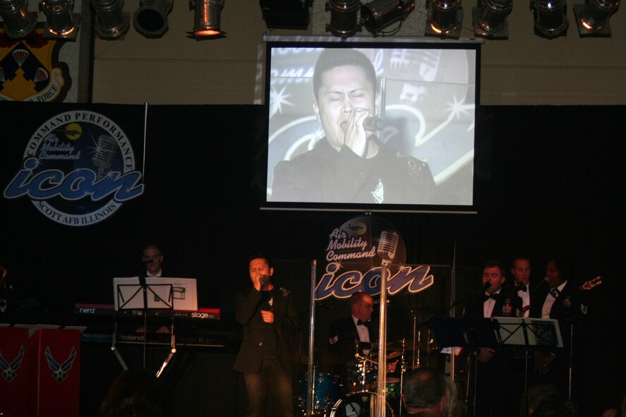 Staff Sgt. Mel Penaflorida sings "Unchained Melody" during the Air Mobility Command Icon finals competition Oct. 20, 2011, at Scott Air Force Base, Ill. Penaflorida made it to the finals by winning the base level competition at Joint Base Charleston, S.C. Icon is an AMC commander's initiative to showcase the vocal talents of AMC Airmen. Each AMC base holds Icon contests in July and August to determine their representatives for the command final which takes place at Scott AFB. (U.S. Air Force Photo/Master Sgt. Scott T. Sturkol)