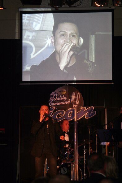 Staff Sgt. Mel Penaflorida sings "Unchained Melody" during the Air Mobility Command Icon finals competition Oct. 20, 2011, at Scott Air Force Base, Ill. Penaflorida made it to the finals by winning the base level competition at Joint Base Charleston, S.C. Icon is an AMC commander's initiative to showcase the vocal talents of AMC Airmen. Each AMC base holds Icon contests in July and August to determine their representatives for the command final which takes place at Scott AFB. (U.S. Air Force Photo/Master Sgt. Scott T. Sturkol)
