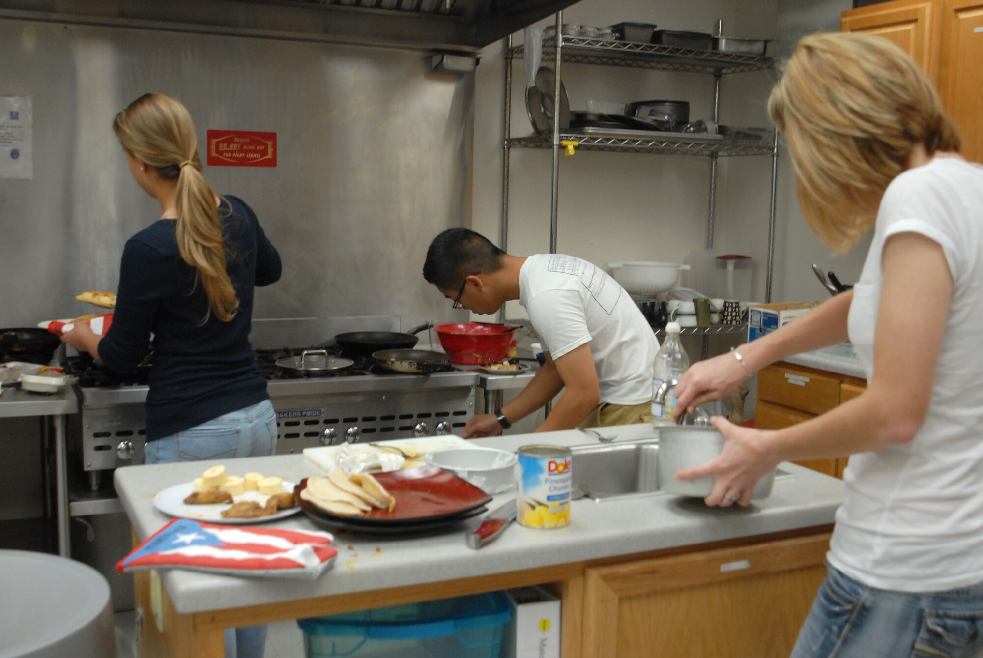 GOODFELLOW AIR FORCE BASE, Texas—Members of Team Tu Madre and Team 341, both comprised of 315th Training Squadron students, battle it out during the final round of Goodfellow’s version of the famous Iron Chef competition at Crossroads here Oct. 22. The two teams had one hour to create three dishes spotlighting the secret ingredient: plantains. (U.S. Air Force photo/Airman 1st Class Jessica Keith)