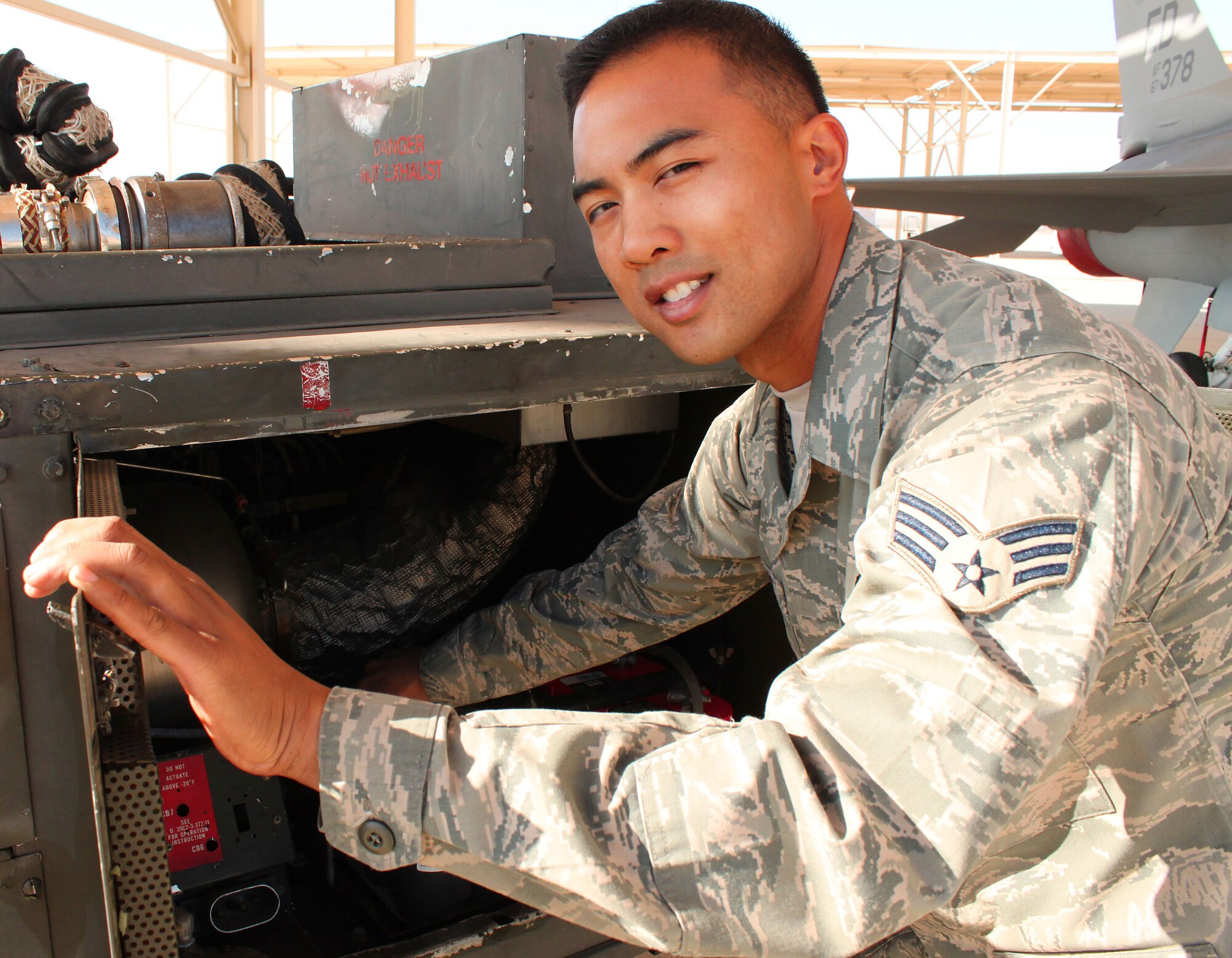 Senior Airman Thomas Castro, Aerospace Ground Equipment journeyman, 412th Maintenance Squadron, checks the batteries on a piece of AGE equipment here. The Staff Sgt. select is Edwards Air Force Base's Warrior of the Week Oct. 28. (U.S. Air Force photo by Meredith Mingledorff) 