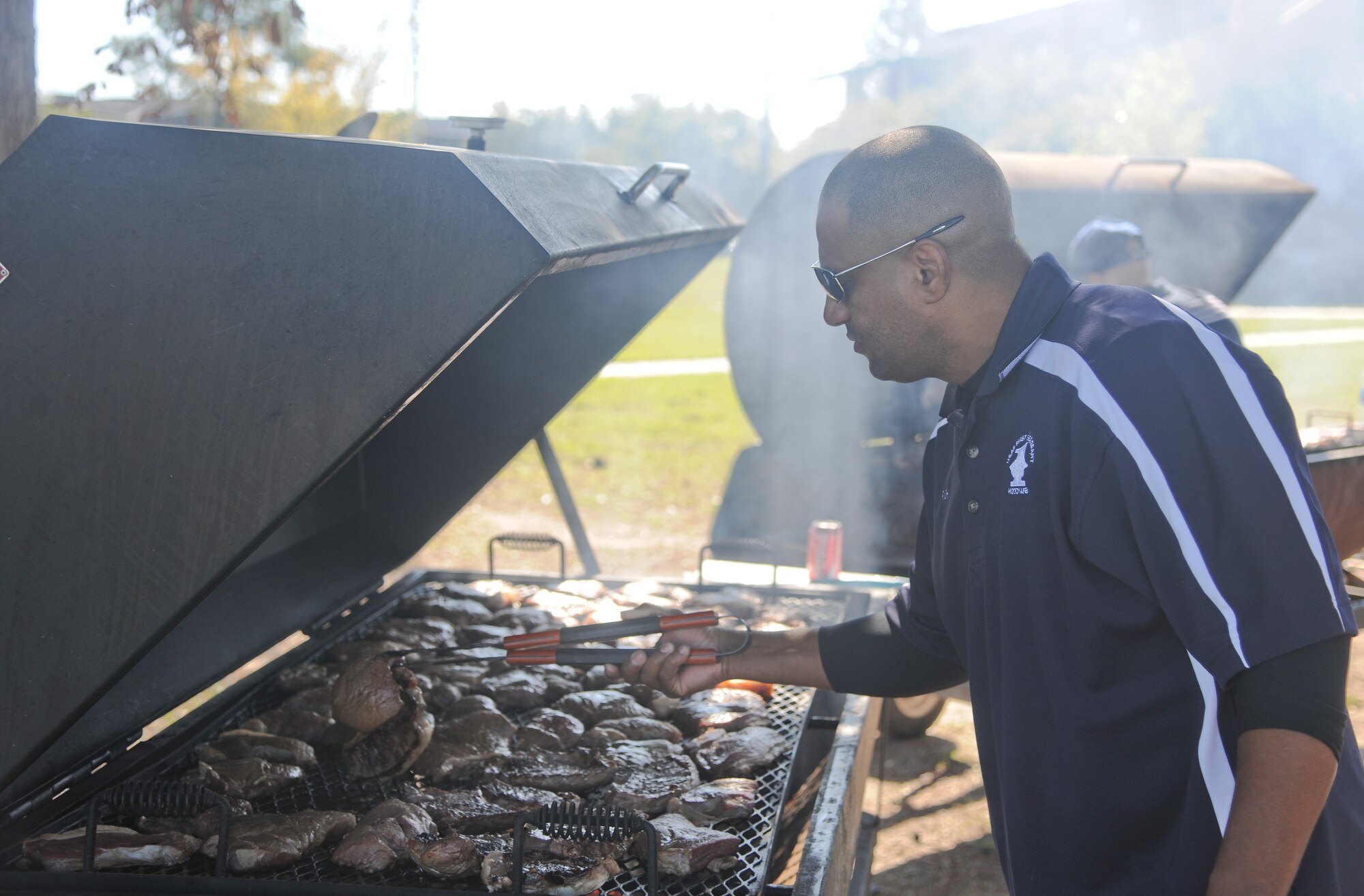 U.S Air Force Senior Master Sgt. Gerald Richard, 23rd Equipment Maintenance Squadron first sergeant, prepares steaks during a first sergeants cookout at Moody Air Force Base, Ga., Oct. 21, 2011. Richard was part of a team of first sergeants who came together and cooked for members of the Moody community. (U.S. Air Force photo by Airman 1st Class Paul Francis/Released)




