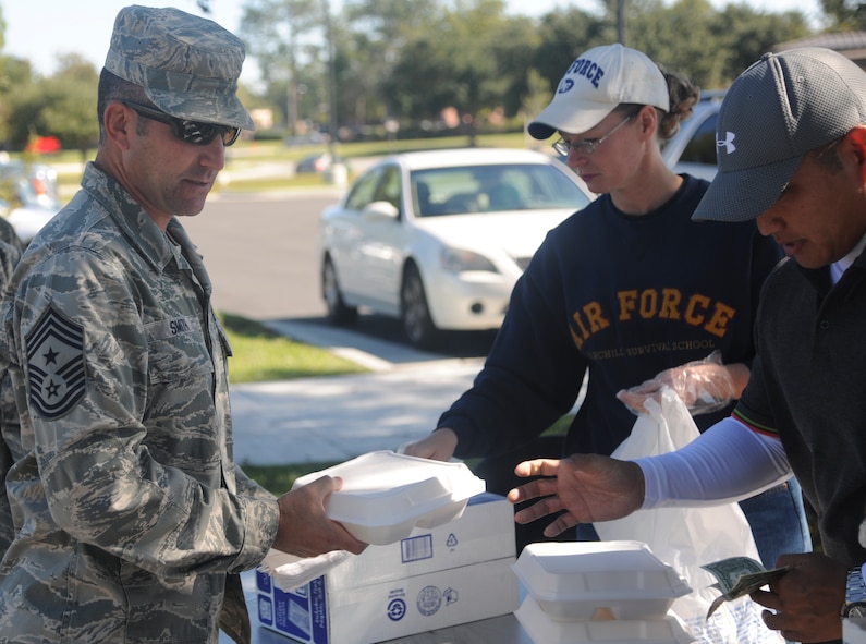 U.S. Air Force Chief Master Sgt. Atticus Smith, 93d Air Ground Operations Wing command chief, receives his meal during the first sergeants cookout at Moody Air Force Base, Ga., Oct. 21, 2011. The meals consisted of steak, beans, mash potatoes and bread. It was served hot off the grill by Moody’s first sergeant corp. (U.S. Air Force photo by Airman 1st Class Paul Francis/Released)


