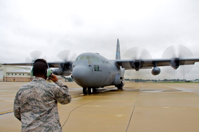 An Airman keeps in contact with fellow maintainers as engines run on C-130H aircraft tail number 40207 from the 166th Airlift Wing on the Delaware Air National Guard ramp at the New Castle ANG Base, Del. on Sept. 22, 2011. (U.S. Air Force photo/Tech. Sgt. Lionel Castellano)