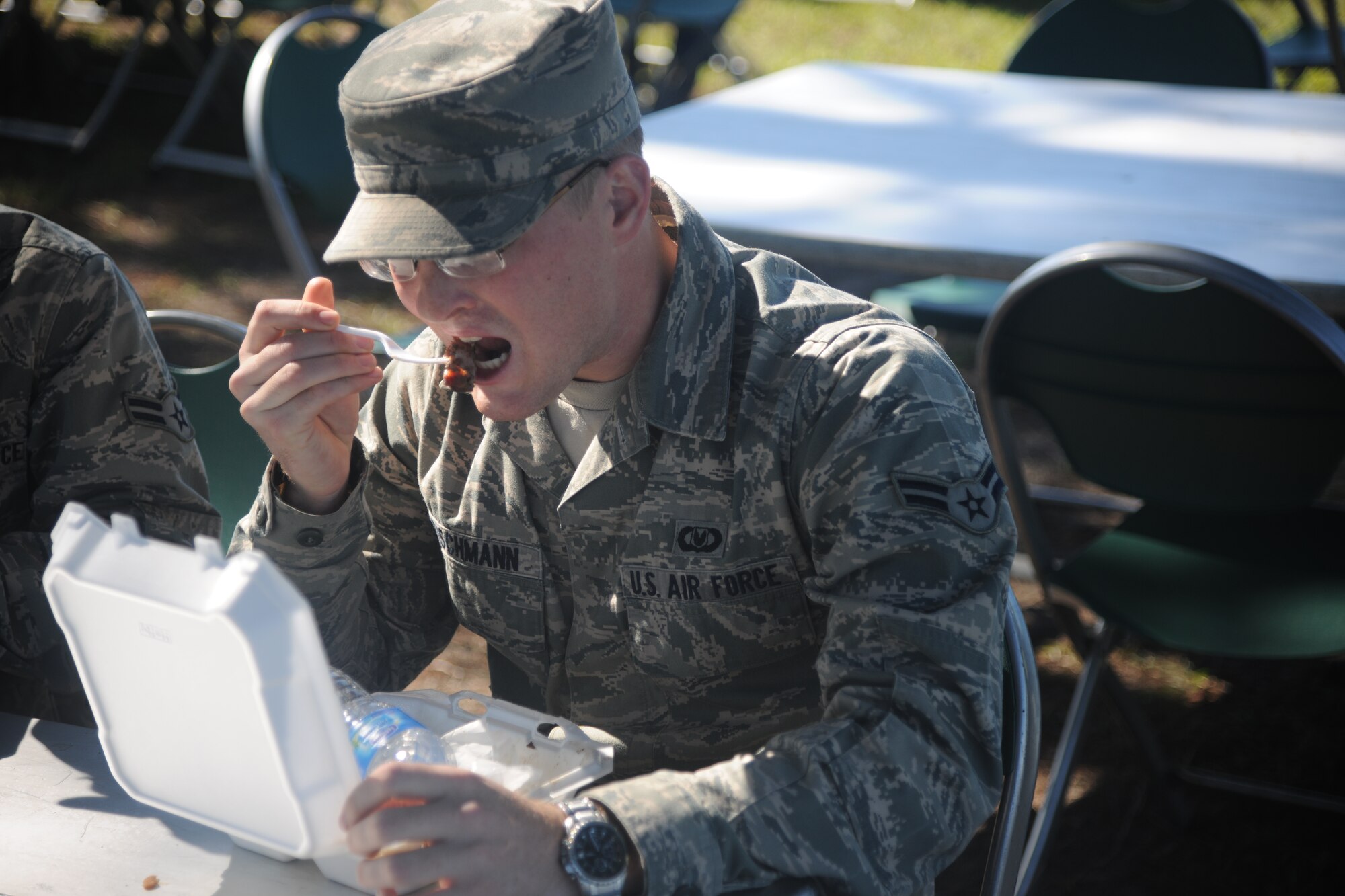 U.S. Air Force Airman 1st Class John Reischmann, 347th Operations Support Squadron, eats his meal during a first sergeants cookout at Moody Air Force Base, Ga., Oct. 21, 2011. Money raised during the cookout will go toward future Moody community events. (U.S. Air Force photo by Airman 1st Class Paul Francis/Released) 


