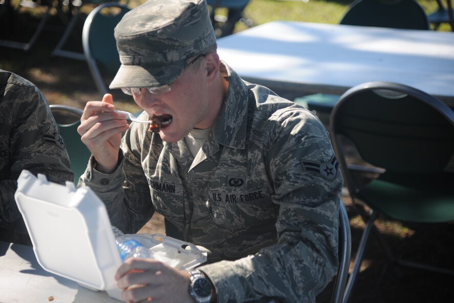 U.S. Air Force Airman 1st Class John Reischmann, 347th Operations Support Squadron, eats his meal during a first sergeants cookout at Moody Air Force Base, Ga., Oct. 21, 2011. Money raised during the cookout will go toward future Moody community events. (U.S. Air Force photo by Airman 1st Class Paul Francis/Released) 


