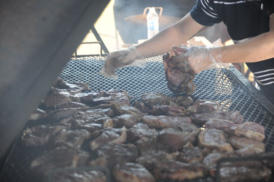 Steaks are grilled by a first sergeant during a cookout outside of the Georgia Pines Dining Facility Oct. 21, 2011, at Moody Air Force Base, Ga. The event was held and organized by first sergeants but other Airmen and civilians also pitched in to help. The proceeds of the cookout will be used for future Moody morale events. (U.S. Air Force photo by Airman 1st Class Paul Francis/Released)



