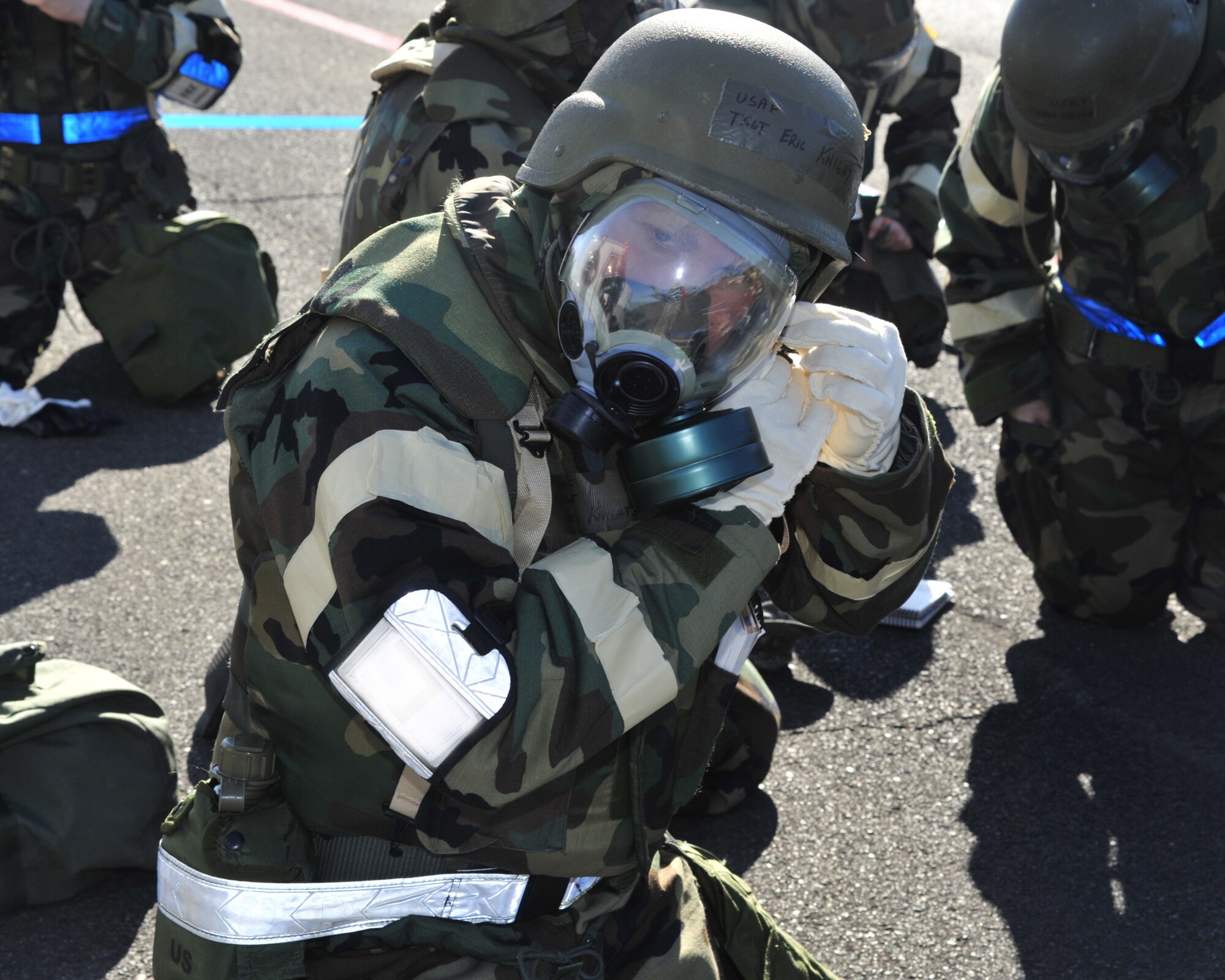 Tech. Sgt. Eric Knight, 62nd Aircraft Maintenance Squadron, adjusts his helmet chin strap after donning his gas mask during a mobility exercise Oct. 18, 2011, at Joint Base Lewis-McChord, Wash. The 62nd Airlift Wing and 627th Air Base Group conducted a mobility exercise, or MOBEX, from Oct. 14 to 21. (U.S. Air Force illustration/Staff Sgt. Frances Kriss)