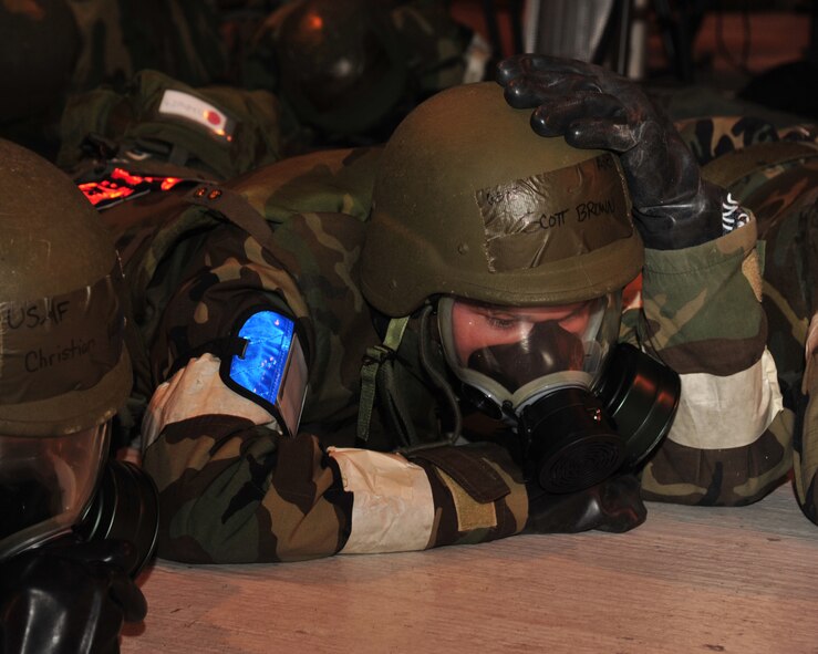 Airman 1st Class Scott Brown, 62nd Aerial Port Squadron, stays in the prone position during a simulated air attack during a mobility exercise Oct. 18, 2011, at Joint Base Lewis-McChord, Wash. The purpose of the mobility exercise, or MOBEX, is to evaluate a unit?s ability to meet wartime and contingency tasks of employing forces, sustaining forces and maintaining the ability to survive and operate in a deployed location. (U.S. Air Force photo/Staff Sgt. Frances Kriss) 