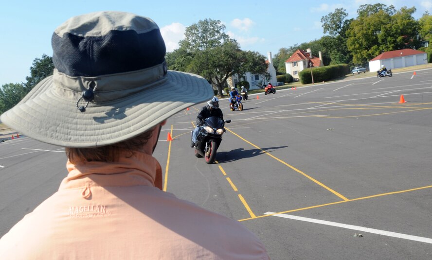 Keith Green, course instructor, watches as members of Barksdale practice riding around the military sport bike training course on Barksdale Air Force Base, La., Oct. 22. The military sport bike riding course is required for all sport bike riders on Barksdale. (U.S. Air Force photo/Senior Airman Kristin High)(RELEASED)