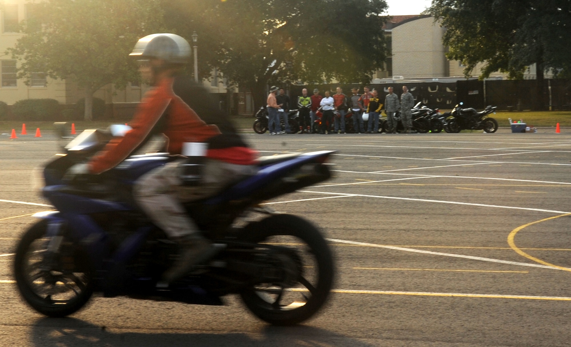 Sport bike riders watch as riding coach, Staff Sgt. Clint Gateley, 2nd Communications Squdran, demonstrates quick-stops during a military sport bike rider course on Barksdale Air Force Base, La., Oct. 22. All sport bike riders are required to complete the course, whether riding on-or off-base. (U.S. Air Force photo/Senior Airman Kristin High)(RELEASED)
